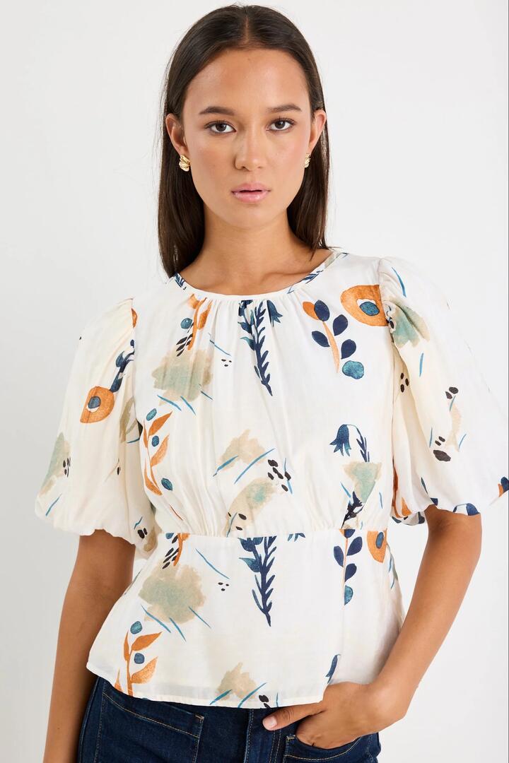 Image of a model wearing Tops. Product name - Finali Earthy Botanical Bubble Sleeve Top in Earthy Botanical colour by brand - Stories be Told