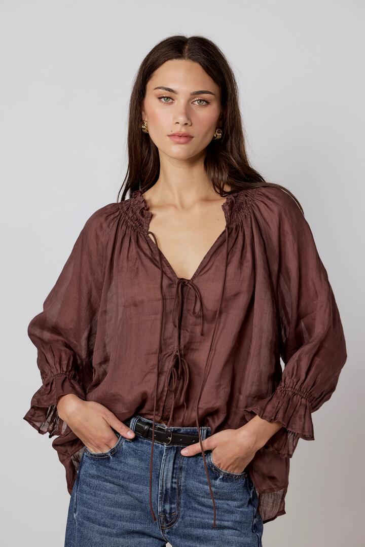Image of a model wearing Tops. Product name - Prospect Chocolate Tie Front Mid Sleeve Top in Chocolate colour by brand - Among the Brave