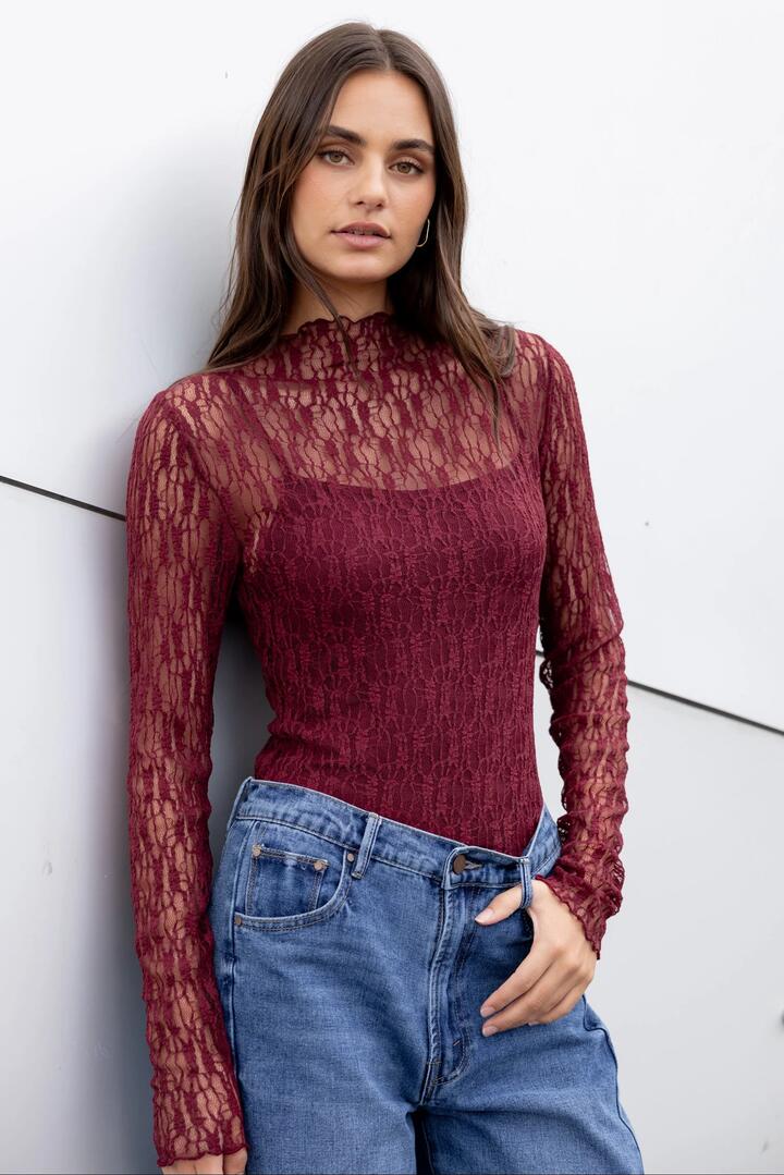 Image of a model wearing Tops. Product name - Giving Burgundy Lace Long Sleeve Top in Burgundy Lace colour by brand - Among the Brave