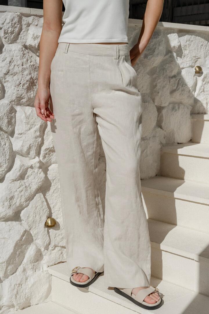 Image of a model wearing Pants. Product name - Bestow Pumice Linen Elastic Back Wide Leg Pants in Pumice colour by brand - By Rosa.
