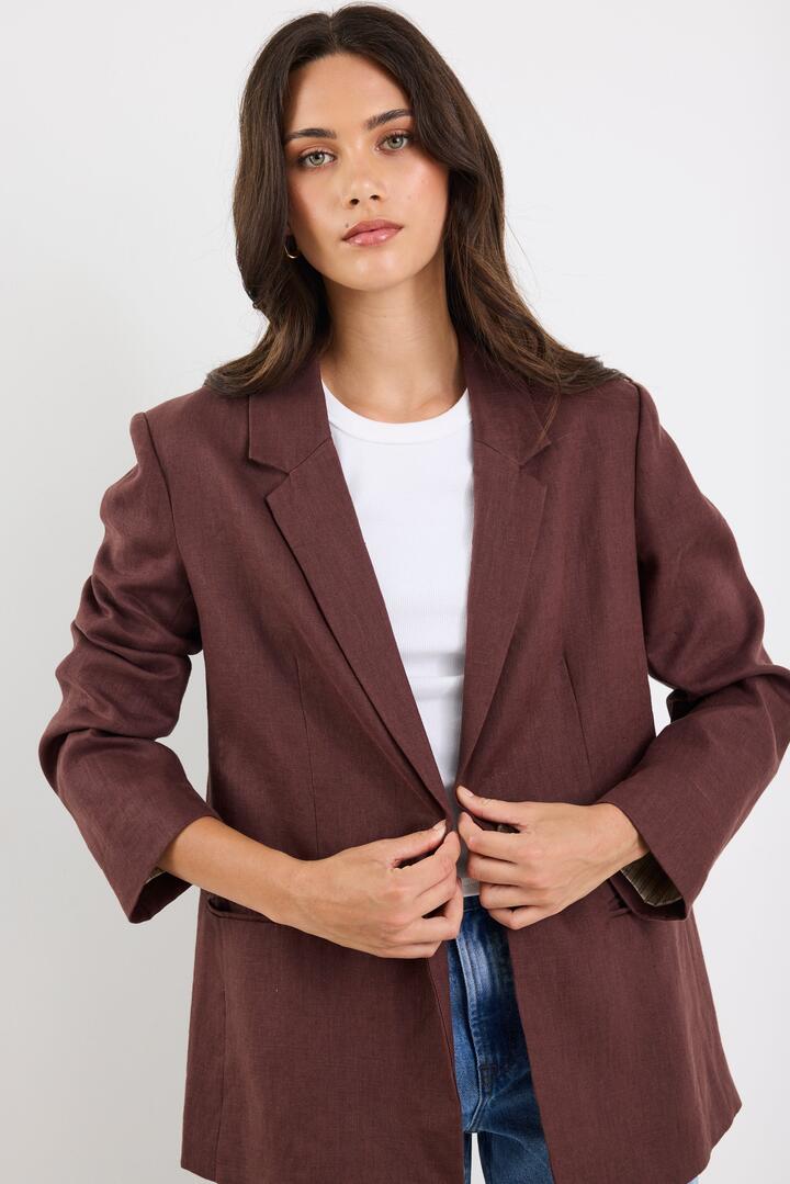 Image of a model wearing Outerwear. Product name - Atlantic Chocolate Linen Classic Blazer in Chocolate colour by brand - RE:UNION Label