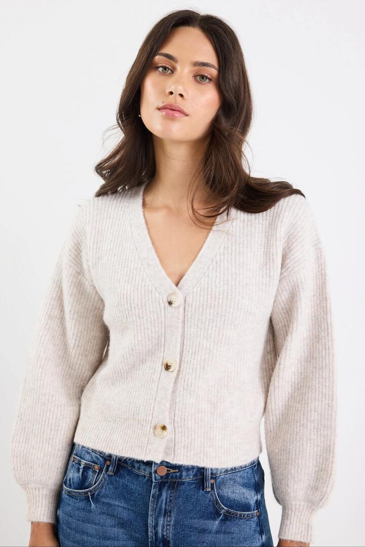 Image of a model wearing Outerwear. Product name - Wholesome Oat Chunky Knit Cardigan in Oat colour by brand - Among the Brave