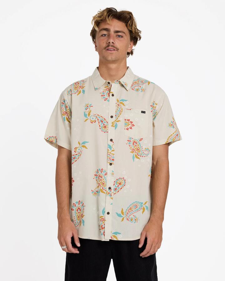 Image of a model wearing Tops. Product name - Billabong Mens Sundays Short Sleeve Shirt Oatmeal in Oatmeal colour by brand - Billabong