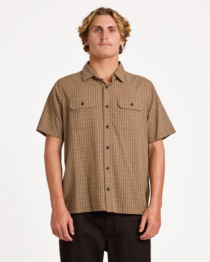 Image of a model wearing Tops. Product name - Volcom Mens Revel Short Sleeve T-Shirt Earth in Earth colour by brand - Volcom