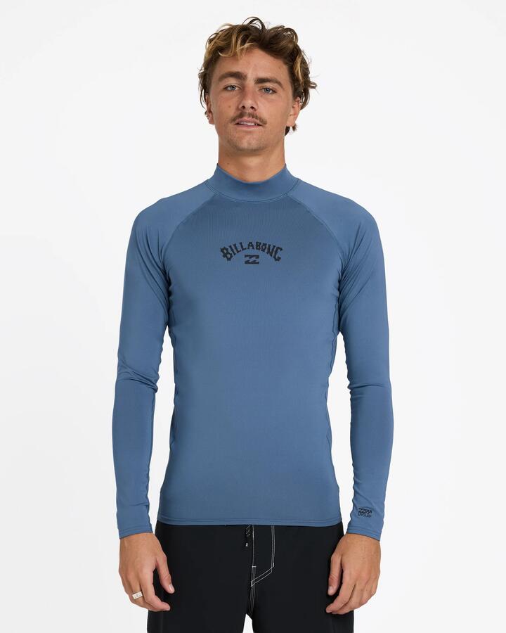 Image of a model wearing Tops. Product name - Billabong Mens All Day Arch Pf Long Sleeve Rash Vest Steel Blue in Steel Blue colour by brand - Billabong