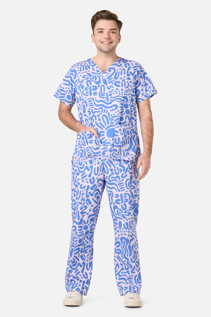 Image of a model wearing Uniforms & Workwear. Productname: Wuk-tjarra Scrub Set in Blue colour by brand - Scrubs With Love