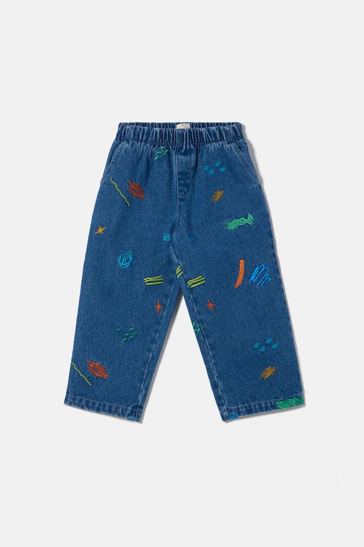 Image of a model wearing Pants. Product name - Maxi Doodles Kids Pants in Denim colour by brand - Gorman