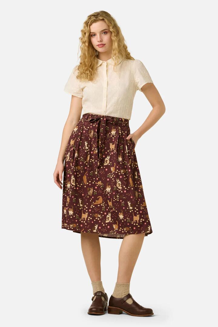 Image of a model wearing Skirts. Productname: Cute Cats Midi Skirt in Plum colour by brand - Princess Highway