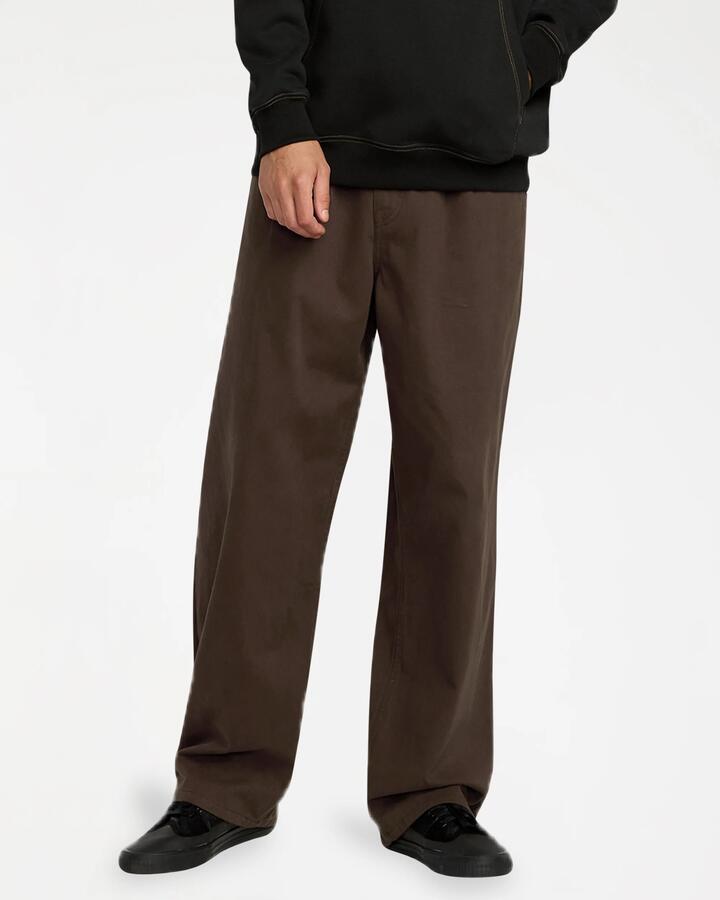 Image of a model wearing Pants. Product name - Volcom Mens Chillow Pleat Pants Cacao in Cacao colour by brand - Volcom