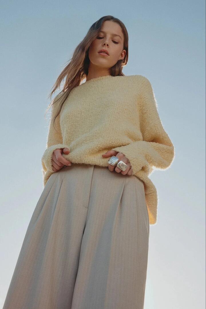 Image of a model wearing Outerwear. Product name - Torin Buttermilk Crew Knit in Yellow colour by brand - Nude Lucy