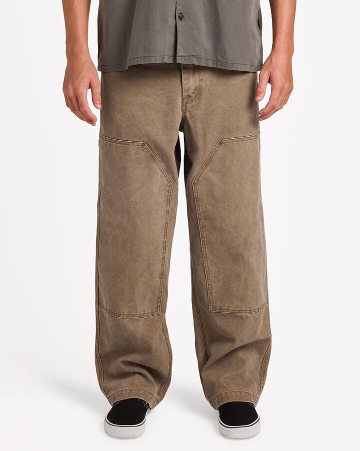 Image of a model wearing Pants. Product name - Volcom Mens Work Carpenter Pants Earth in Earth colour by brand - Volcom