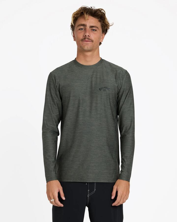 Image of a model wearing Tops. Product name - Billabong Mens Shoreline Loose Fit Long Sleeve Rash Vest Military Heather in Military Heather colour by brand - Billabong