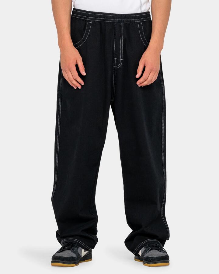 Image of a model wearing Pants. Product name - Rusty Mens Flip Daddy Elastic Waist Pants Black in Black colour by brand - Rusty