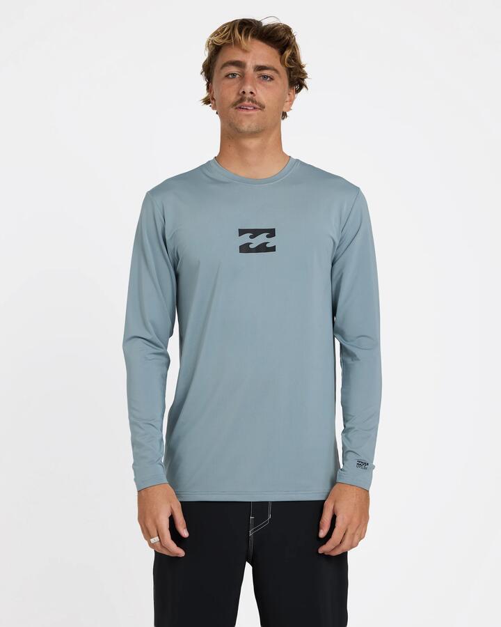 Image of a model wearing Tops. Product name - Billabong Mens All Day Wave Long Sleeve Rashguard Blue Fog in Blue Fog colour by brand - Billabong
