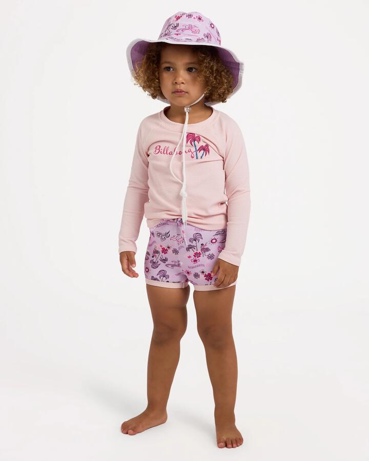 Image of a model wearing Tops. Product name - Billabong Girls 0-5 Hula Haze Long Sleeve Rash Vest Magnolia in Magnolia colour by brand - Billabong