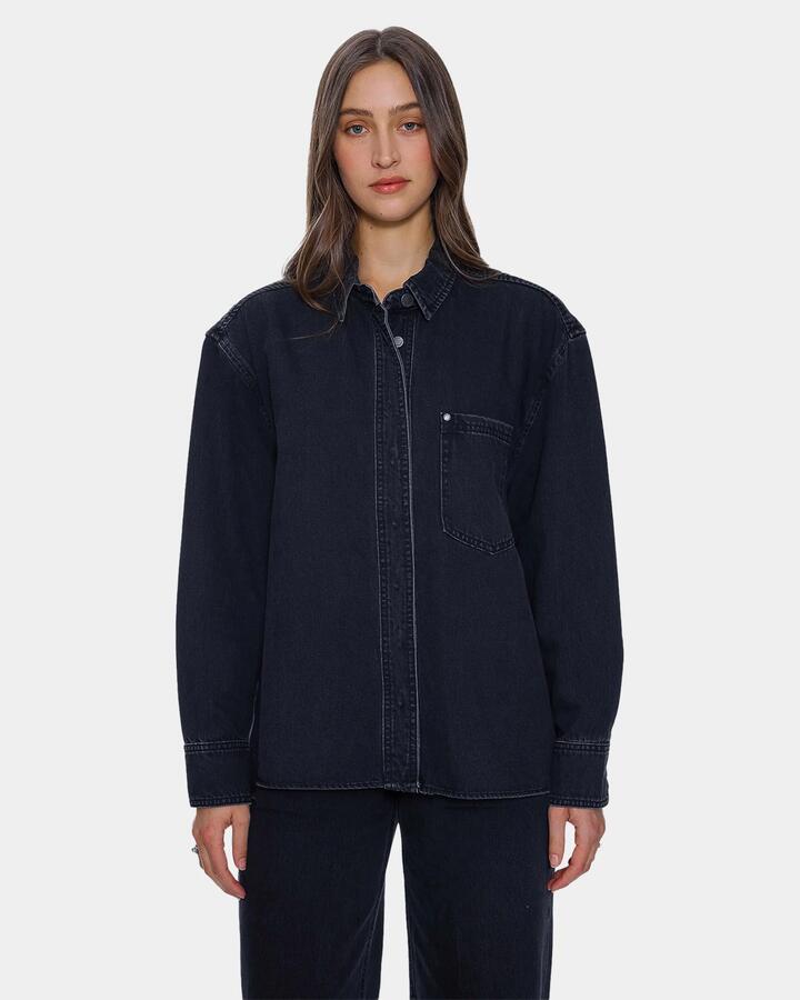 Image of a model wearing Tops. Product name - Thrills Womens Melina Oversized Denim Long Sleeve Shirt Aged Black in Aged Black colour by brand - Thrills