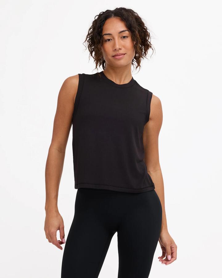 Image of a model wearing Tops. Product name - Rvca Womens Rvca Muscle Tank Top Rvca Black in Rvca Black colour by brand - Rvca