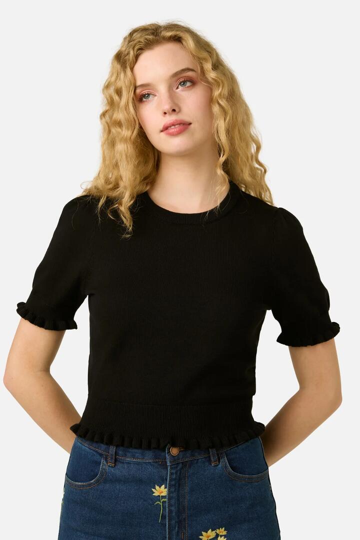 Image of a model wearing Tops. Product name - Zoe Ruffle Knit Top in Black colour by brand - Princess Highway