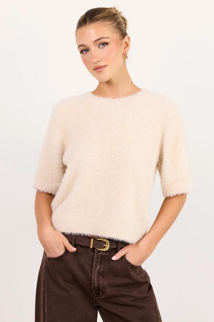 Image of a model wearing Outerwear. Product name - Issue Stone Fluffy Soft Knit Tee in Stone colour by brand - Ivy + Jack