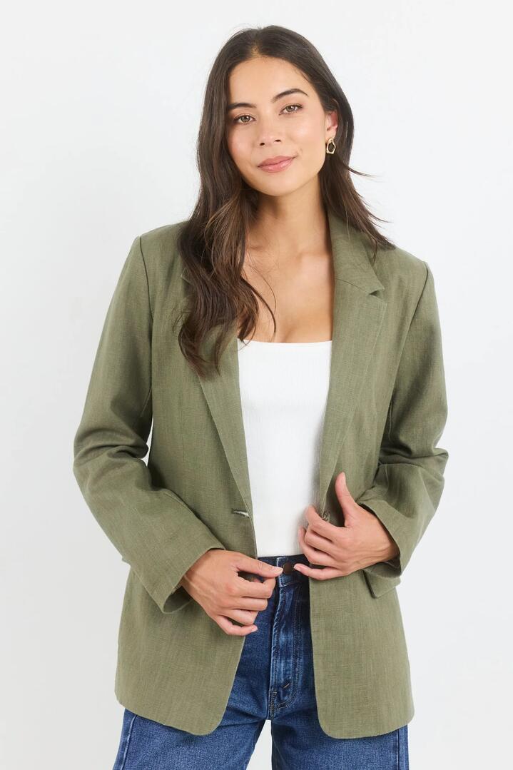 Image of a model wearing Outerwear. Product name - Dock Soft Khaki Ramie Rolled Sleeve Blazer in Soft Khaki colour by brand - Ivy + Jack