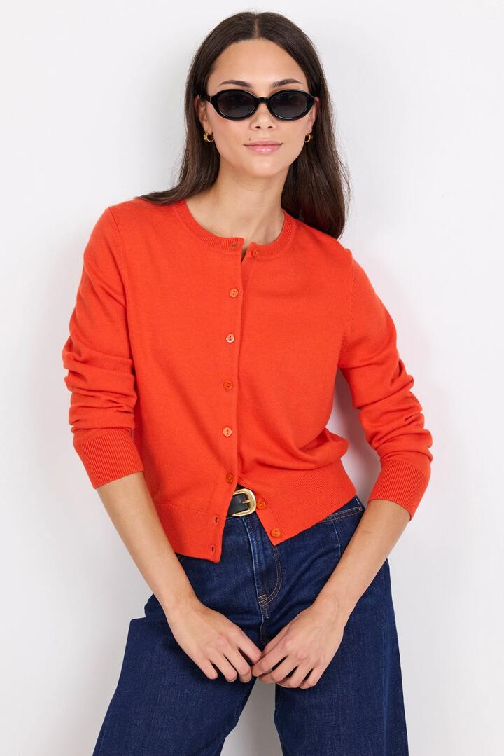 Image of a model wearing Outerwear. Product name - Autograph Blood Orange Soft Fine Gauge Crewneck Cardigan in Blood Orange colour by brand - Stories be Told