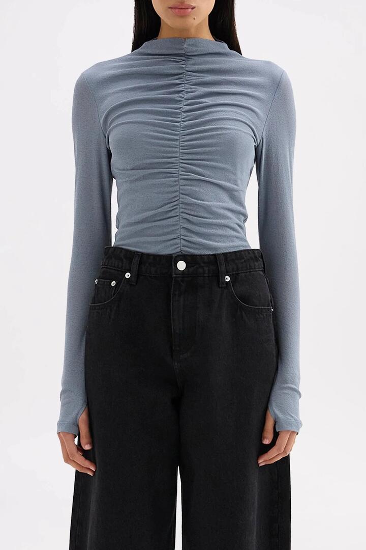 Image of a model wearing Tops. Product name - Marti Nickel Blue Ruched Front Ruched Front LS Mesh Top in Blue colour by brand - Nude Lucy