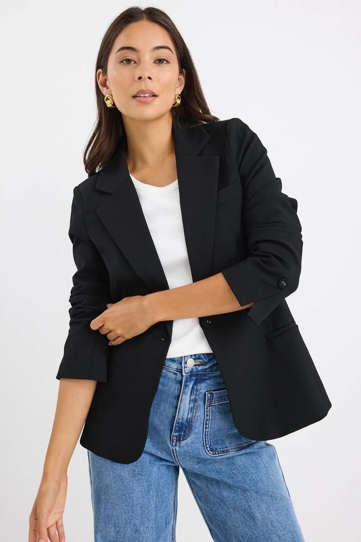 Image of a model wearing Outerwear. Product name - Suave Black Fitted Short Blazer in Black colour by brand - Stories be Told