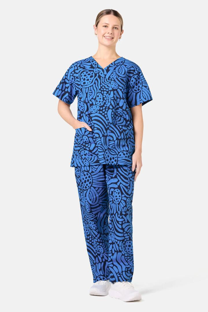 Image of a model wearing Uniforms & Workwear. Product name - Breezy Waters Scrub Set in Navy colour by brand - Gorman