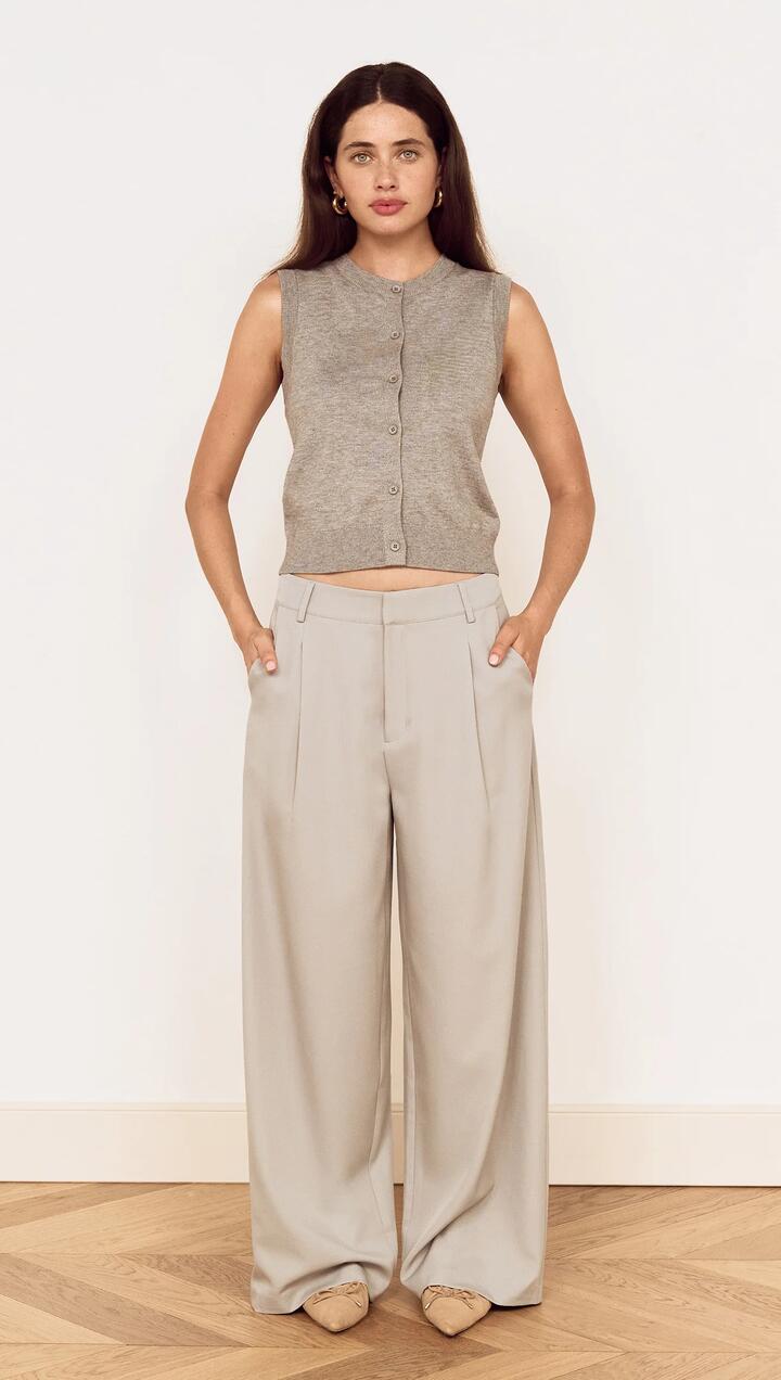 Image of a model wearing Pants. Product name - Mid Rise Tailored Suit Pant in Grey in Grey colour by brand - MINKPINK