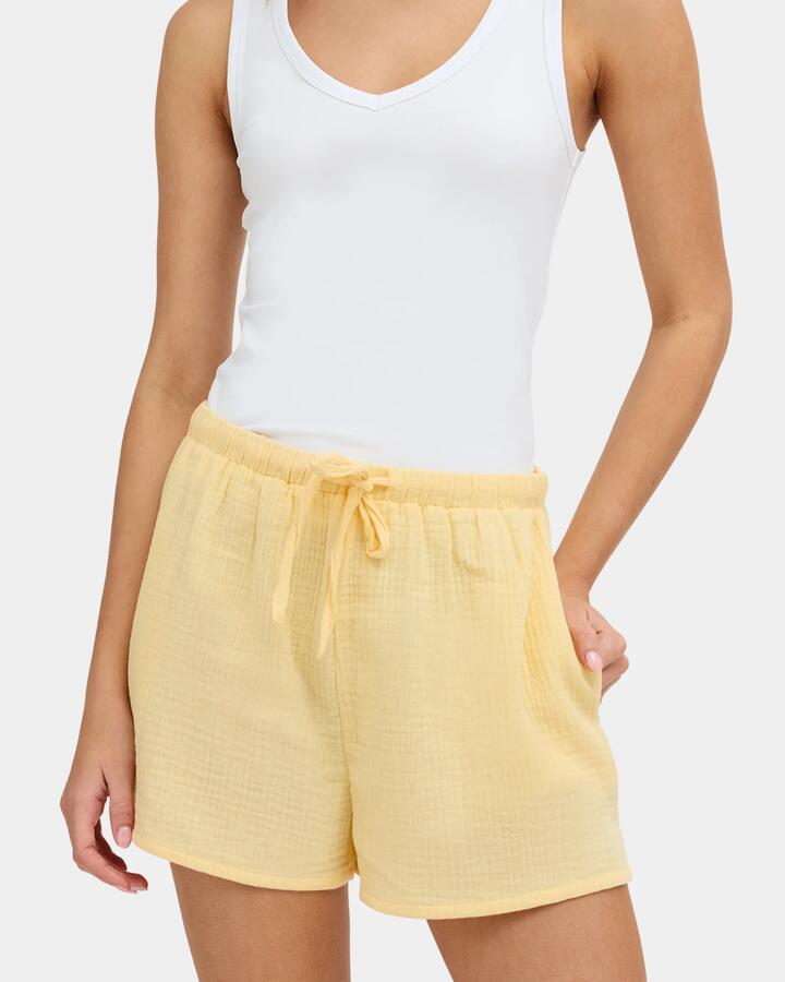 Image of a model wearing Shorts. Product name - Nunui Womens Paloma Elastic Waist Shorts Butter in Butter colour by brand - Nunui