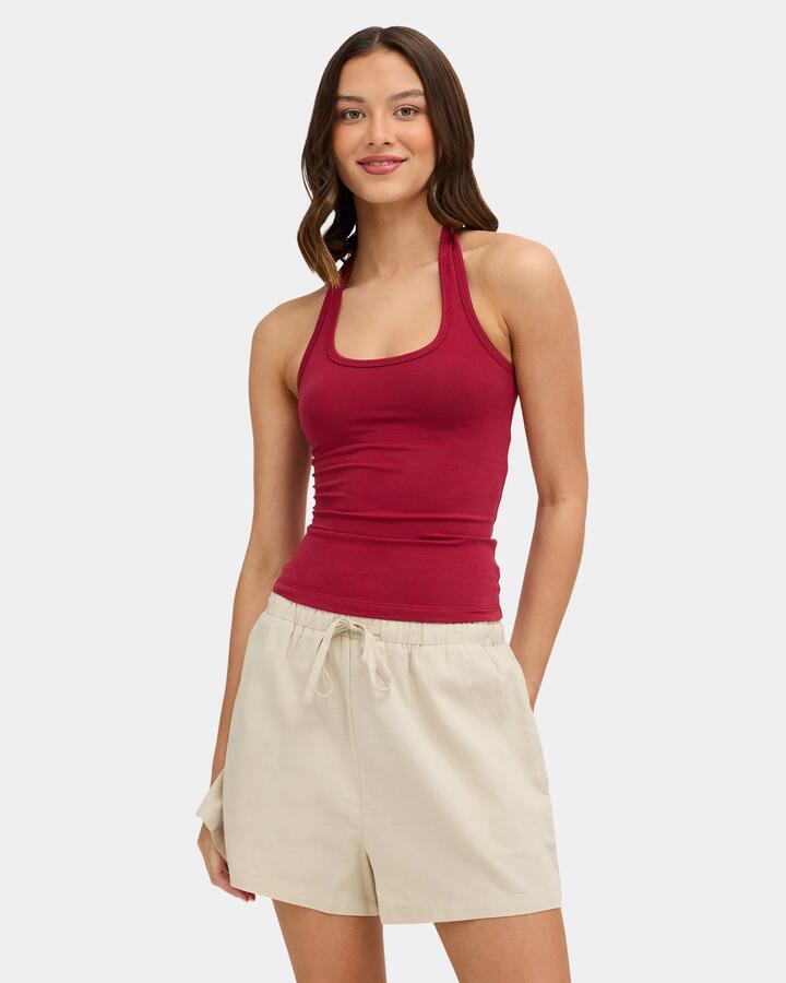 Image of a model wearing Tops. Product name - Nunui Womens Hug Me Halter Tank Top Red in Red colour by brand - Nunui
