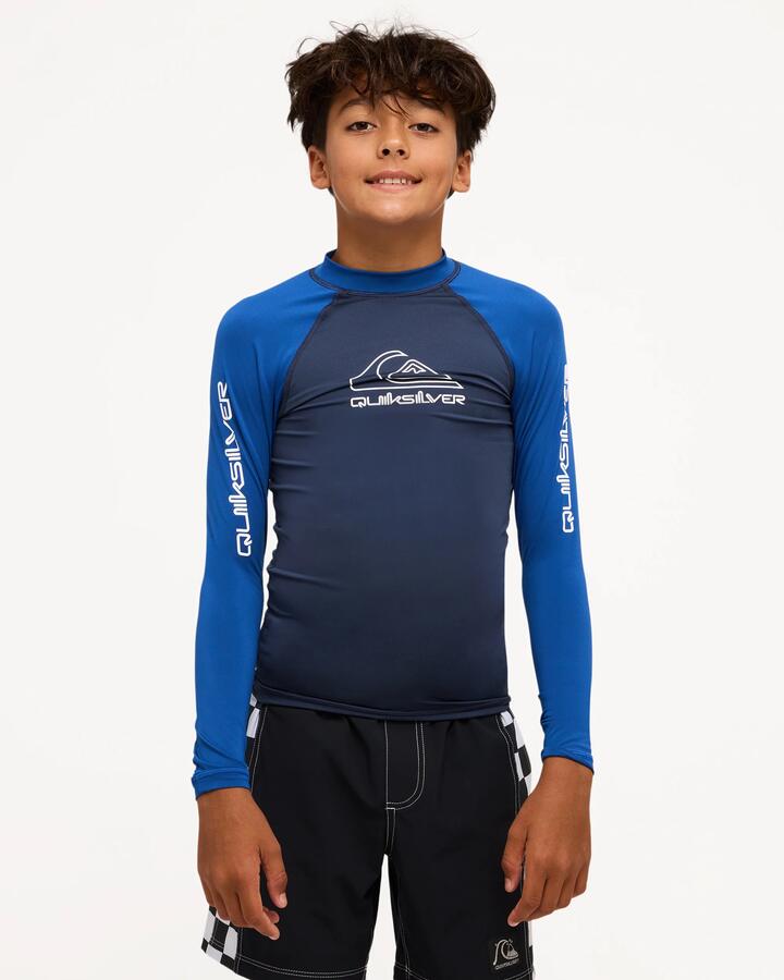 Image of a model wearing Tops. Product name - Surf Dive 'n Ski Boys 8-16 On Tour Long Sleeve Id Rashguard Mood Indigo in Mood Indigo colour by brand - Surf Dive 'n Ski