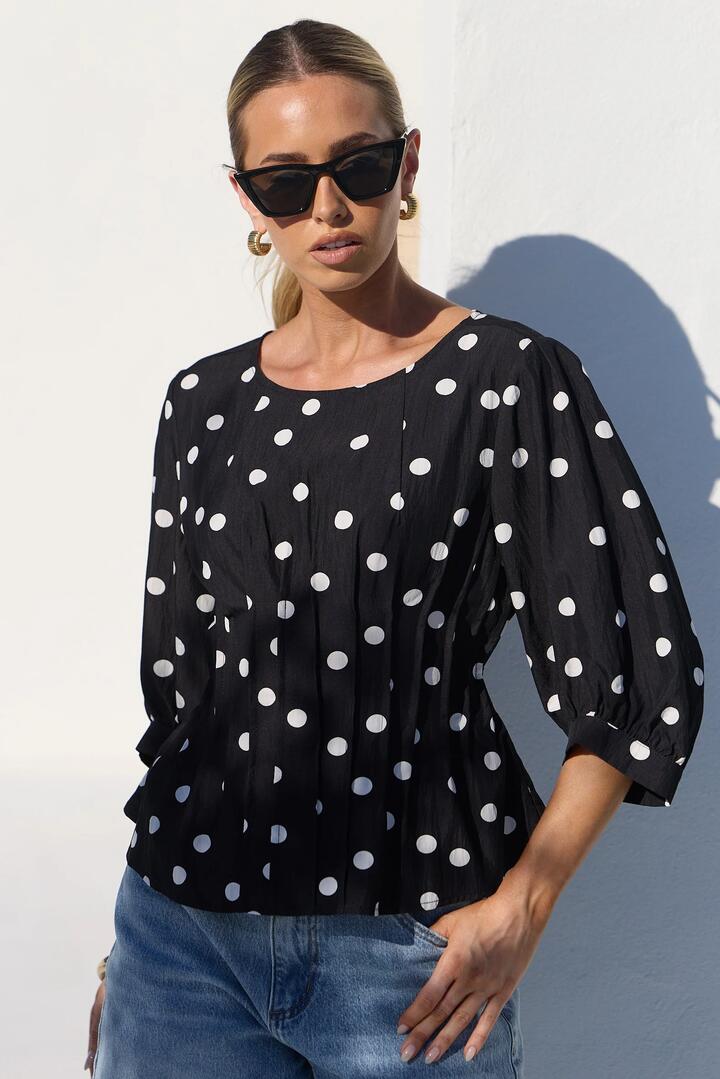 Image of a model wearing Tops. Product name - Theatrical Black Polka Dot Pintuck Shaped SS Top in Black Polka Dot colour by brand - Stories be Told