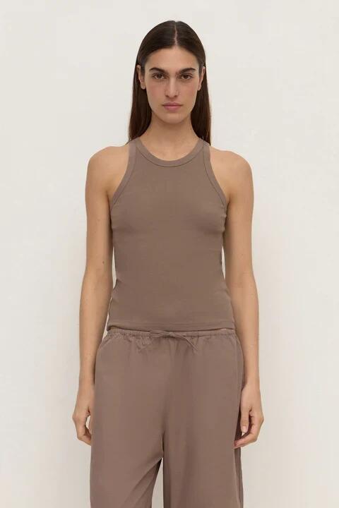 Image of a model wearing Tops. Product name - Tabitha Dark Sand Rib Tank in Natural colour by brand - Assembly Label