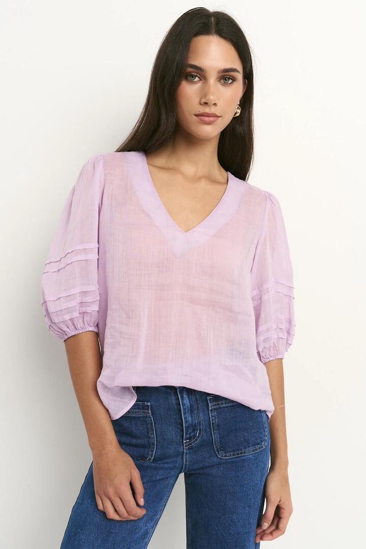 Image of a model wearing Tops. Product name - Recall Lilac Ramie Pleat Sleeve Crew Top in Lilac Ramie colour by brand - Ivy + Jack