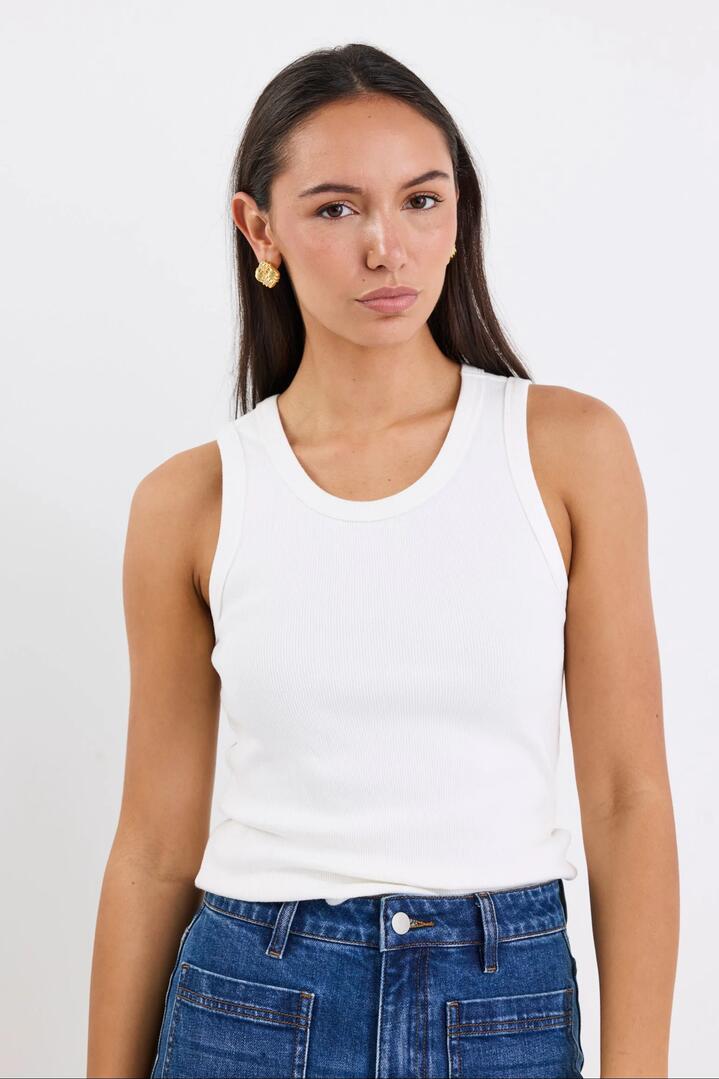Image of a model wearing Tops. Product name - Cobble Ivory Rib Cutaway Tank in Ivory colour by brand - RE:UNION Label