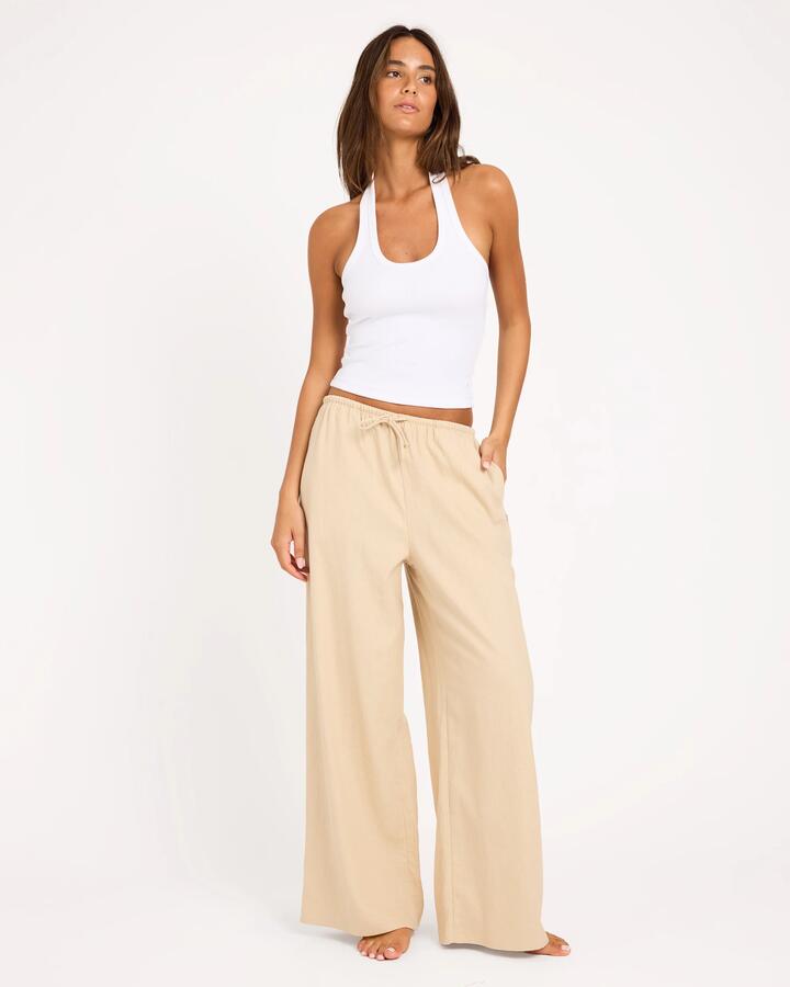 Image of a model wearing Pants. Product name - Roxy Womens Lolani Elastic Waist Pants Parchment in Parchment colour by brand - Roxy