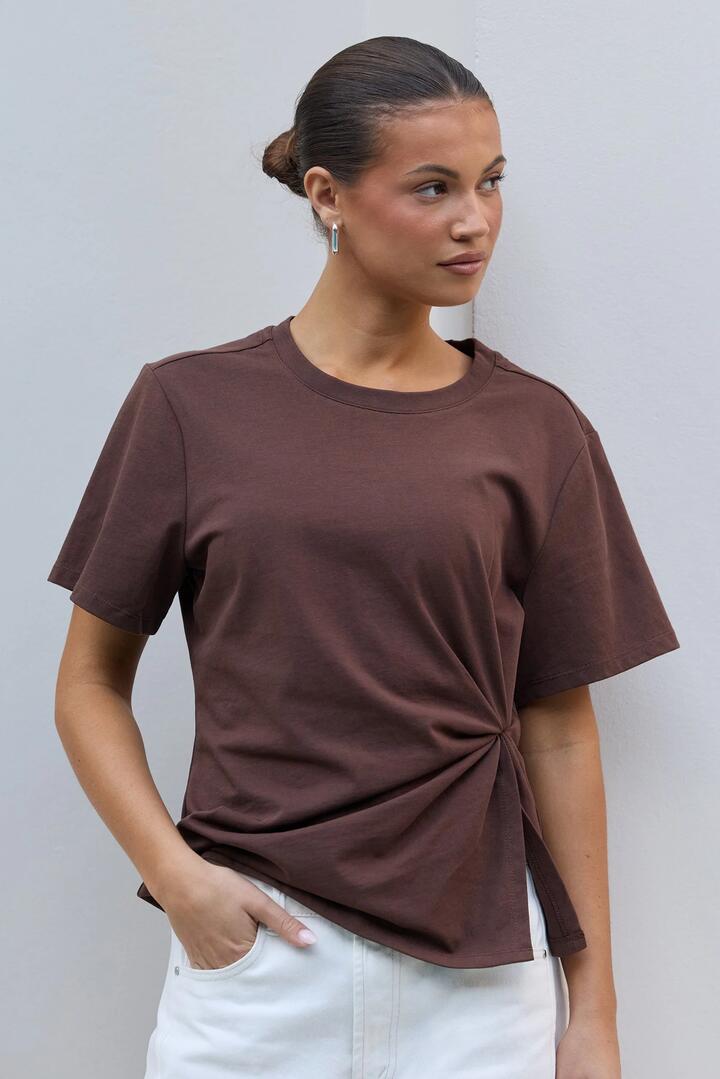 Image of a model wearing Tops. Product name - Rupture Chocolate Split Detail Tee in Chocolate colour by brand - Ivy + Jack
