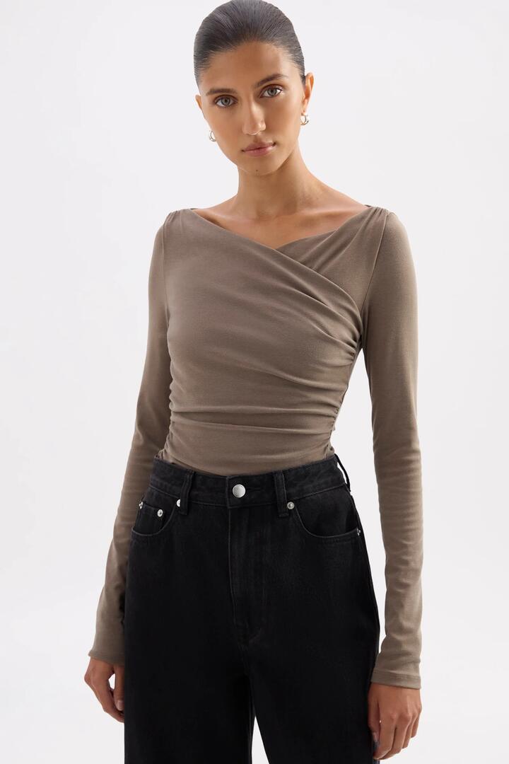 Image of a model wearing Tops. Product name - Daniya Truffle Front Cross LS Top in Brown colour by brand - Nude Lucy