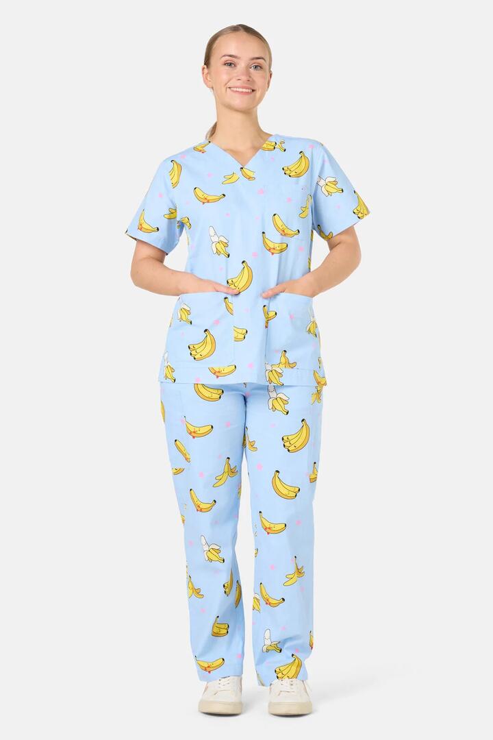 Image of a model wearing Uniforms & Workwear. Product name - Bananas Scrub Set in Light Blue colour by brand - Scrubs With Love