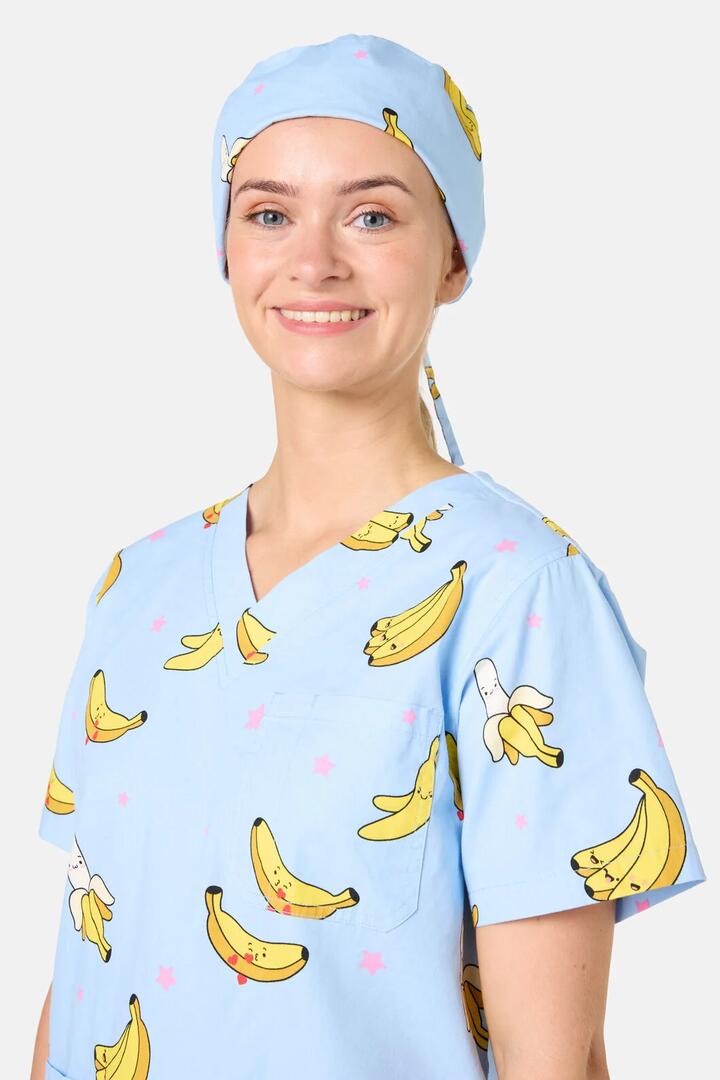 Image of a model wearing Uniforms & Workwear. Product name - Bananas Scrub Hat in Light Blue colour by brand - Scrubs With Love