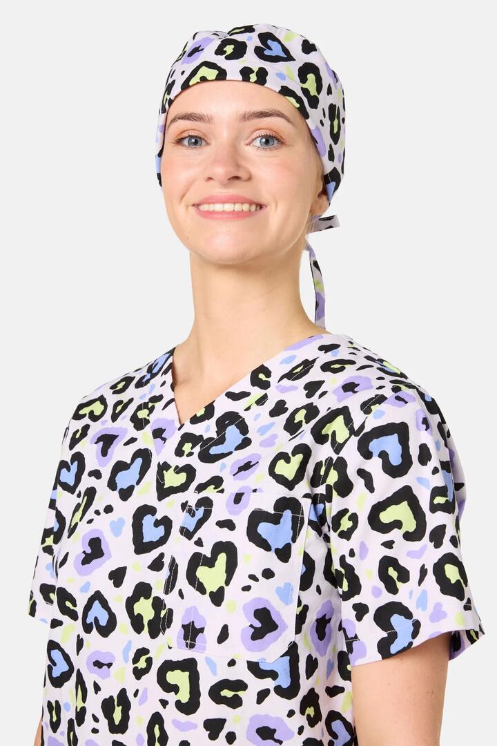 Image of a model wearing Uniforms & Workwear. Product name - Leopard Love Scrub Hat in Lilac colour by brand - Scrubs With Love