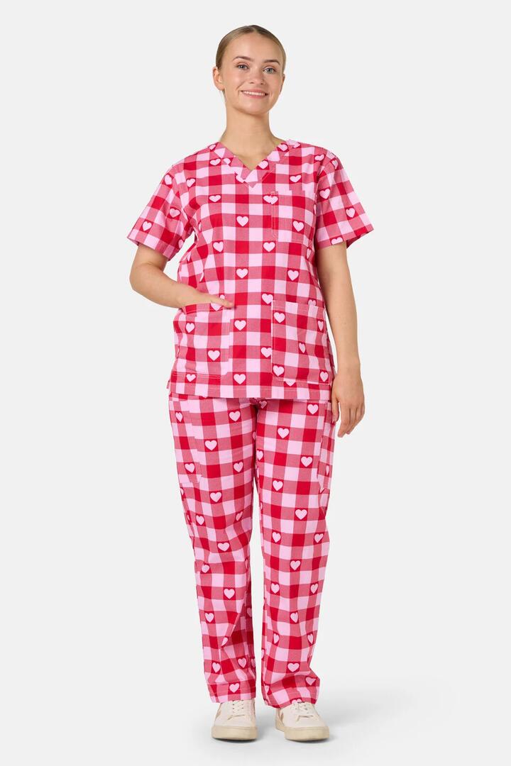 Image of a model wearing Uniforms & Workwear. Product name - Heartbeat Scrub Set in Pink colour by brand - Gorman