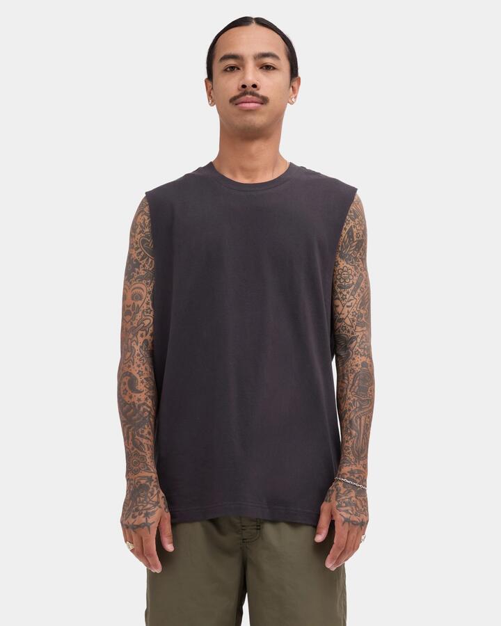 Image of a model wearing Tops. Product name - RVCA Mens Rvca Standard Muscle Pirate Black in Pirate Black colour by brand - RVCA