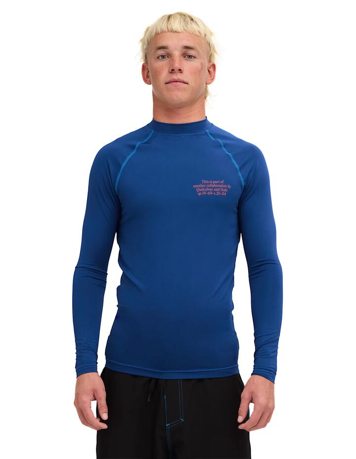 Image of a model wearing Tops. Product name - Quiksilver Mens Stab Long Sleeve Rashguard Estate Blue in Estate Blue colour by brand - Quiksilver