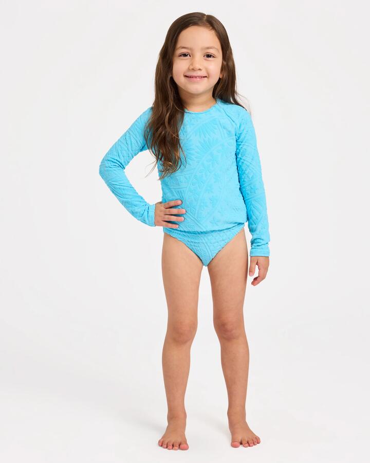 Image of a model wearing Tops. Product name - Roxy Girls 2-7 Surf The Vibes Long Sleeve Rash Vest Two Piece Splish Splash in Splish Splash colour by brand - Roxy