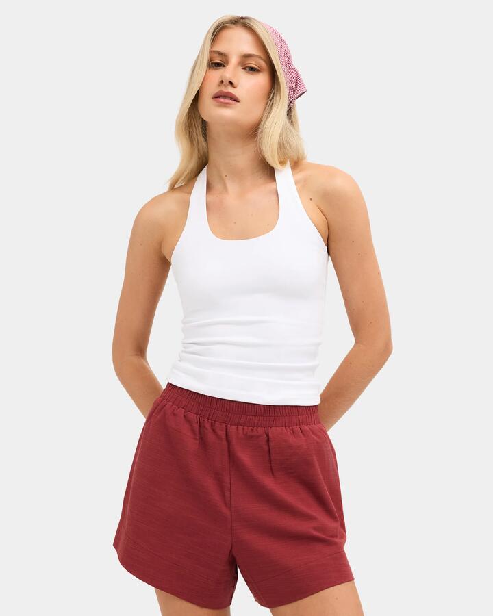 Image of a model wearing Tops. Product name - Nunui Womens Haliday Halter Top White in White colour by brand - Nunui