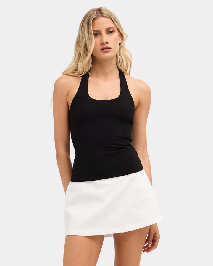 Image of a model wearing Tops. Product name - Nunui Womens Haliday Halter Top Black in Black colour by brand - Nunui