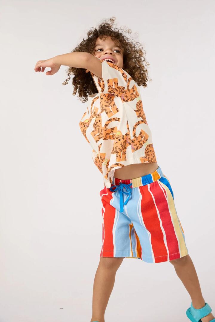 Image of a model wearing Shorts. Product name - Red Stripes Kids Shorts in Red Stripe colour by brand - Gorman