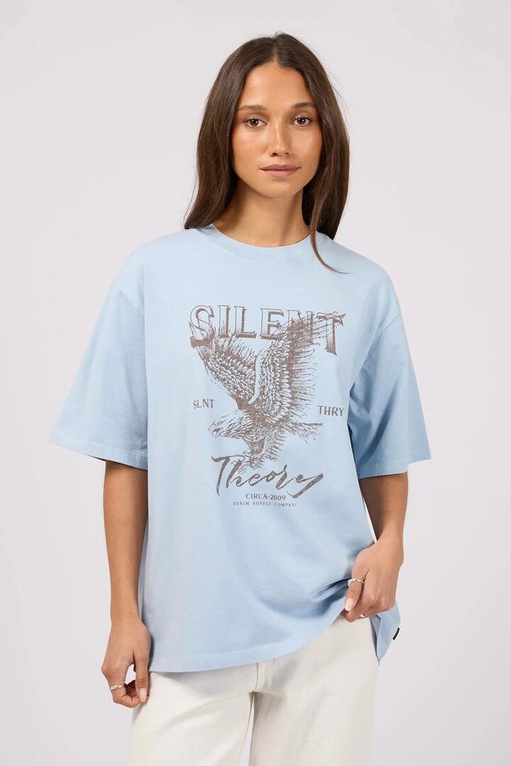 Image of a model wearing Tops. Product name - Fundamental Light Blue Eagle Print Oversized Tee in Blue colour by brand - Silent Theory
